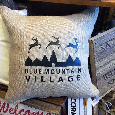 Sand Colored Burlap pillow with custom imprint of the Blue Mountain Village logo with reindeers.