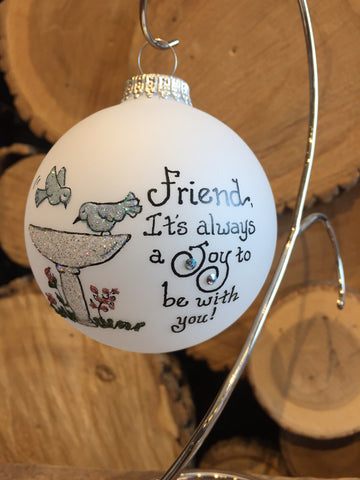 White Frosted Round Ornament depicting a bird bath feature with inscription "Friend, It's always a Joy to be with You" painted in Swarovski Crystals